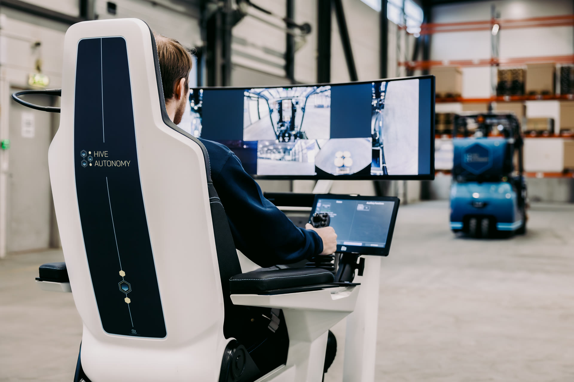 Operator supervising an autonomous forklift from the Hive operation center